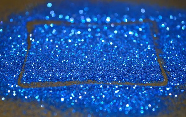 Wazig abstracte achtergrond met rechthoekig frame van blauwe glitter schittert op zwarte ondergrond — Stockfoto