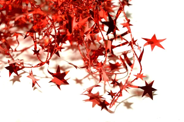 Blurry abstract background of red Christmas garland with red stars on white — Stock Photo, Image