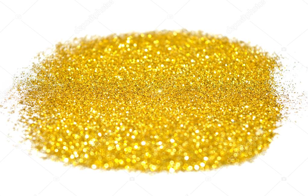 Blurry background of golden glitter sparkles on white surface
