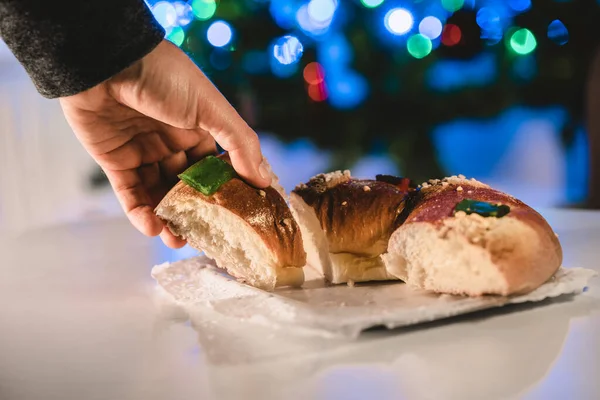 Hand Picking Piece Roscon Reyes Ring Pastry Roll Illuminated Christmas — Stock Photo, Image