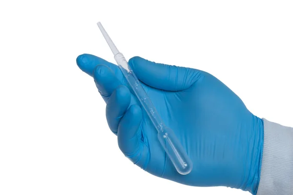 Hand with a Pasteur pipette — стокове фото