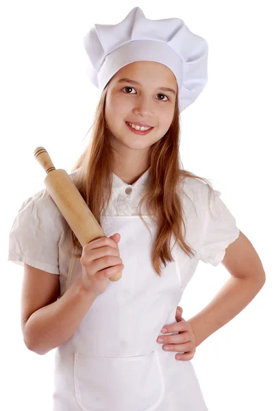 Девушка, одетая как повар, держит булавку — стоковое фото