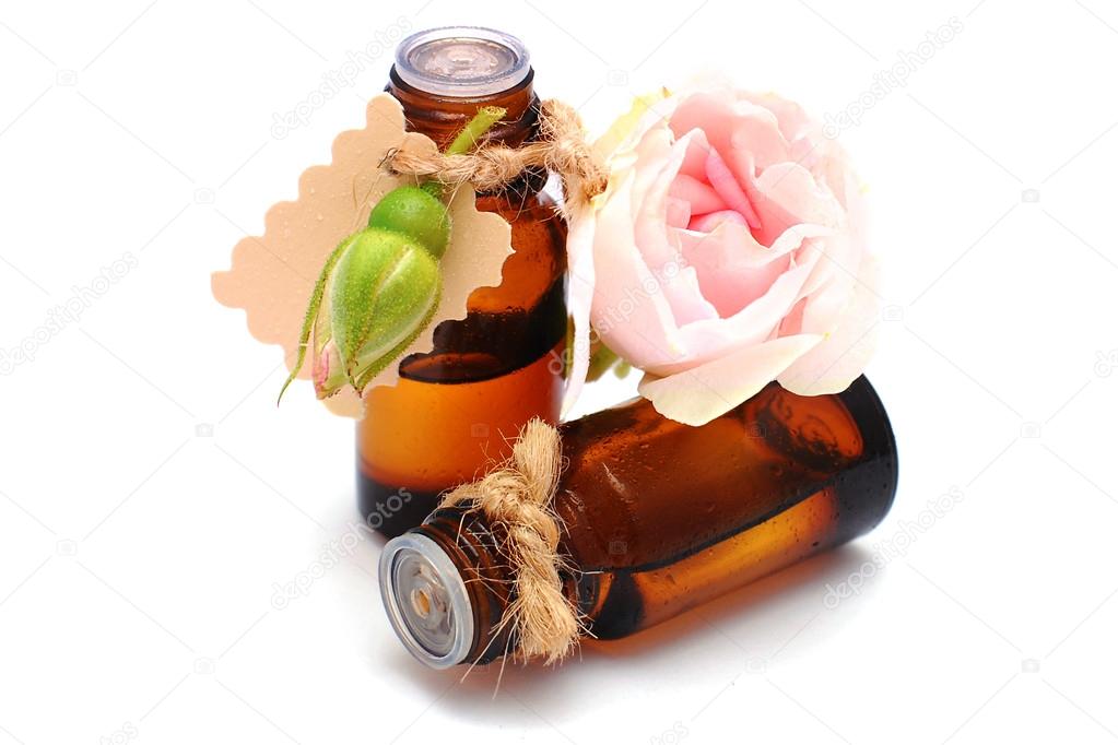 Bottle with rose oil isolated on white background