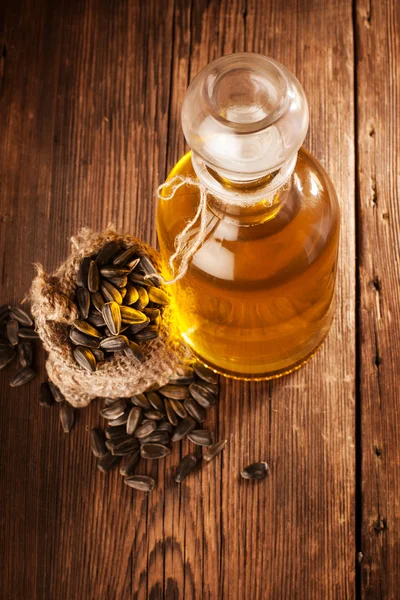 Bottle with sunflower oil on a wooden surface — Stock Photo, Image