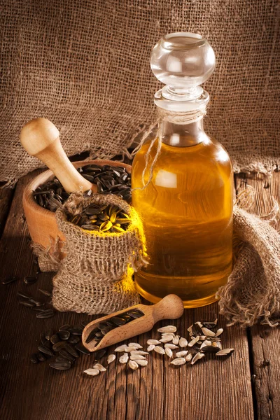 Bottle with sunflower oil on a wooden surface — Stock Photo, Image