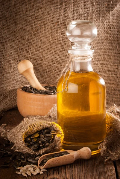 Bottle with sunflower oil on a wooden surface — Stock Photo, Image