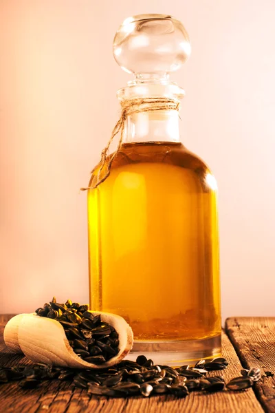 Bottle with sunflower oil on a wooden surface — Stock Photo, Image