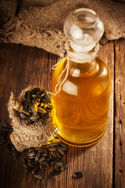 Bottle with sunflower oil on a wooden surface — Stock Photo, Image