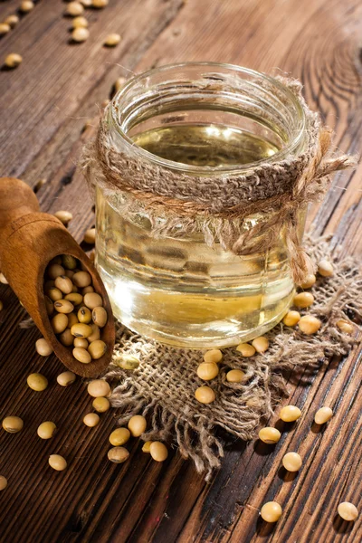 Soybean oil on a wooden background. rustic style — Stock Photo, Image