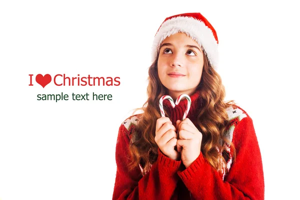 Portrait of a girl in christmas clothes with a gift in hand on isolated white background — Stock Photo, Image