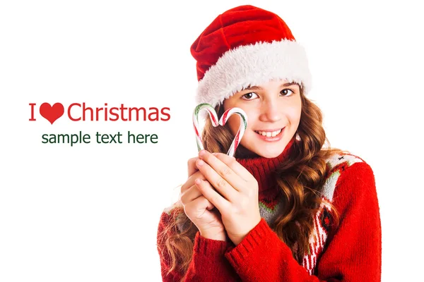 Πορτρέτο του ένα κορίτσι σε ρούχα Χριστούγεννα με ένα δώρο στο χέρι σε απομονωμένες λευκό φόντο — Φωτογραφία Αρχείου