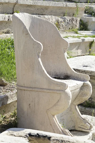 Stone chair in the ancient Theatre of Dionysus Eleuthereus seen from the hill of Athens Acropolis, Greece