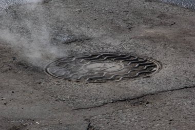 İçinden buhar çıkan bir kapak.