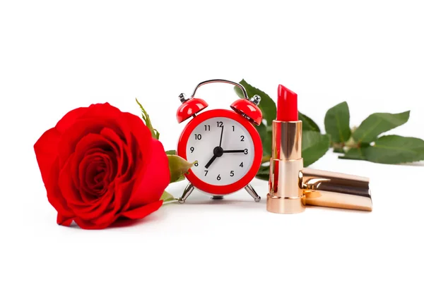 Kırmızı ruj, gül ve beyaz bir arka planda çalar saat