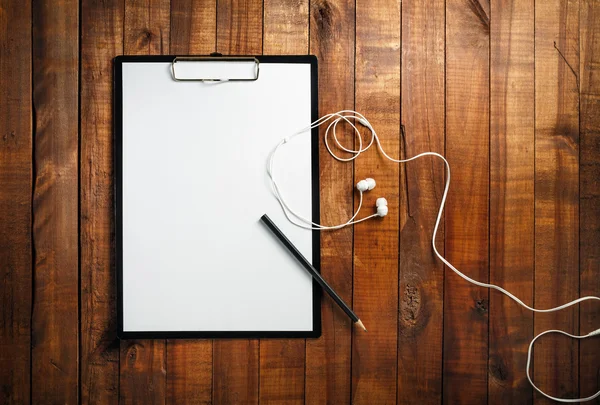 Blank paper, pencil and headphones — Stock Photo, Image