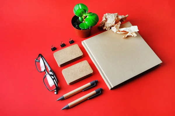 Template for branding identity for designers. Photo of blank stationery set on red paper background.