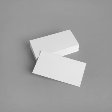 Gri arkaplandaki boş kartvizitlerin fotoğrafı. Kimlik Şablonu.