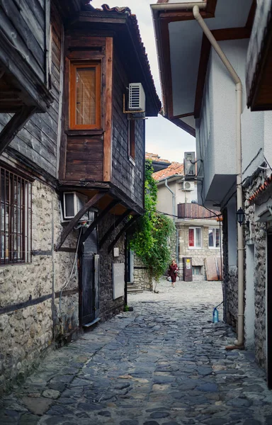 Nesebar, Bulgaristan - 08 Eylül 2014: Bulgaristan 'ın sahil beldesi ve eski Nessebar kasabasında eski evleri olan sokak. UNESCO dünya mirası bölgesi. Dikey çekim.