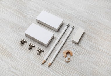 Boş beyaz kartvizitler, tahta arka planda kalem ve silgi. Markalaşma tasarımı için şablon.