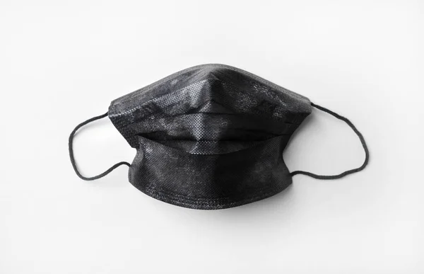 Schwarze Medizinische Schutzmaske Auf Weißem Tischhintergrund Flache Lage — Stockfoto