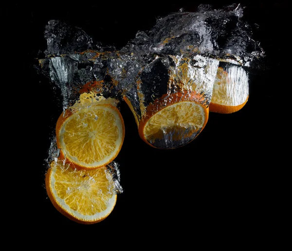 Orangenscheiben in Wasser — Stockfoto