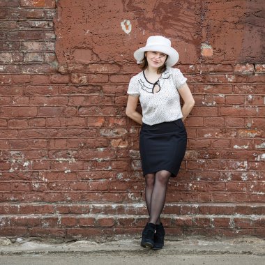 Kadın tuğla duvar arka plan üzerinde