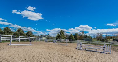 Horse riding arena with jumps clipart
