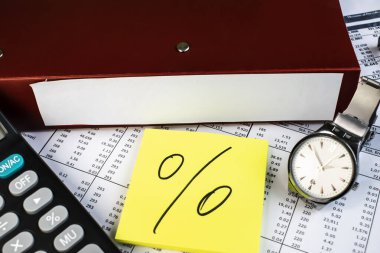 Two folders are on documents with numbers near the clock calculator and a piece of paper that shows the percentage. clipart