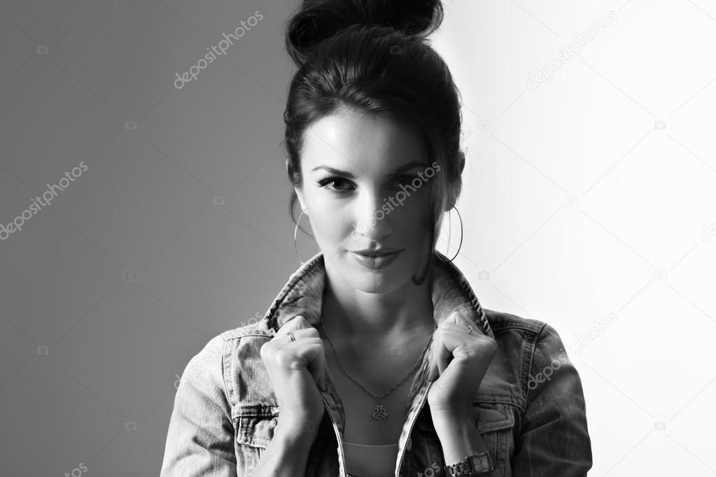 Confident model holding denim collar with retro lighting