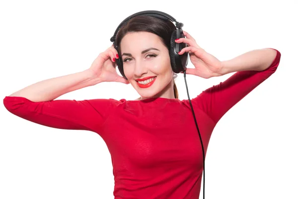 Wunderbares Teenager-Mädchen, das die Musik im großen Kopfhörer hört Stockbild