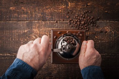 Grinding coffee on the wooden table  top view