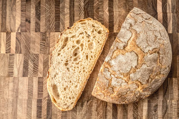 Half of rye bread and a piece on the table — Stock Photo, Image