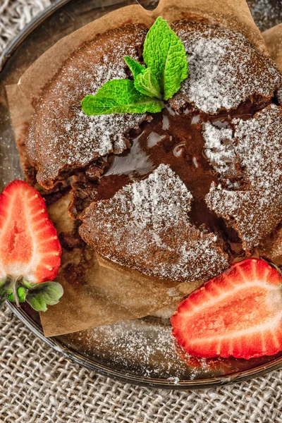 Chocolate fondant  with strawberry and mint on the metal plate vertical — Stock Photo, Image