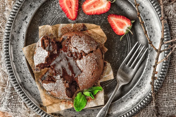 Chocolate fondant on the old metal plate top view — Stock Photo, Image