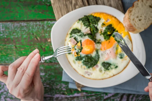 Eating Florentine eggs with purred spinach horizontal — Stock Photo, Image
