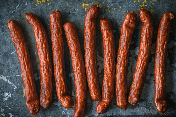 Smoked sausage on a blue metallic background — Stock Photo, Image