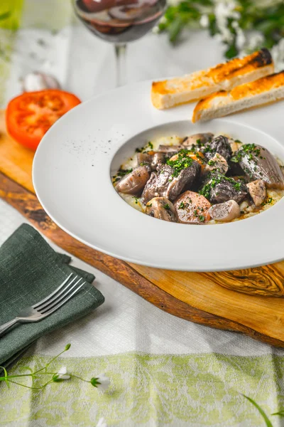 Beef bourguignon in a ceramic plate, tablecloth, tomato, bread a — Stock Photo, Image