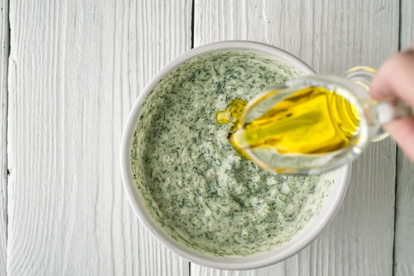 Adding olive oil in tzatziki top view — Stock Photo, Image