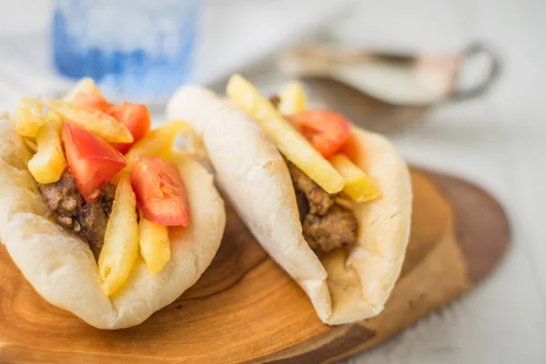 Gyros with potatoes, meat, pita bread and tomato with a gravy bo — Stock Photo, Image