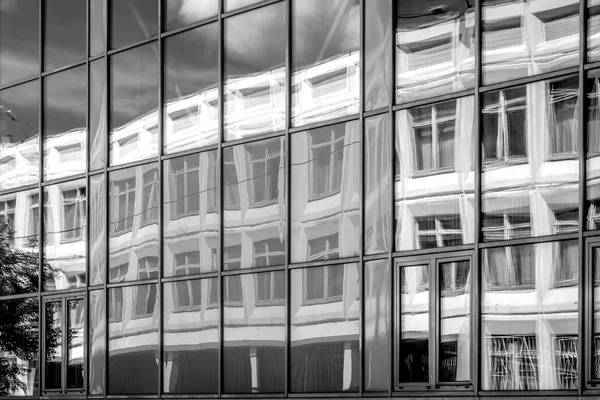 Reflection in the windows of another building black and white — Stock Photo, Image