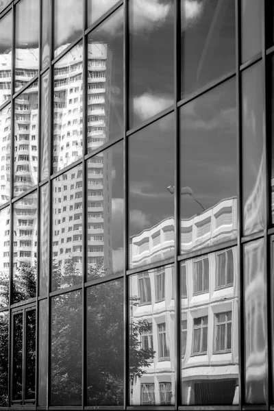 Reflection in the windows of another building black and white vertical — Stock Photo, Image