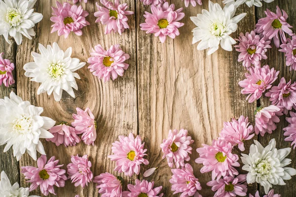 Frame of   pink  and white flower on the wooden table  horizontal