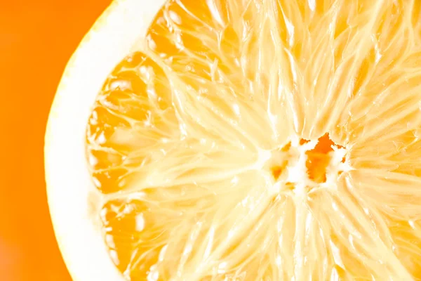 Orange slice on the orange background close-up horizontal