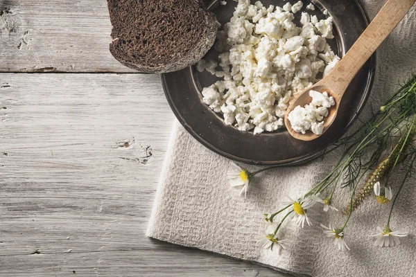 Fiocchi di latte freschi con pane e fiori sul tavolo in legno bianco vista dall'alto — Foto Stock