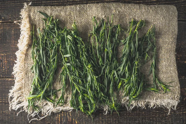 Tarragon on the canvas on the wooden table top view — Stock Photo, Image