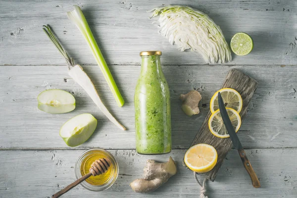 Glass bottle with smoothie with different ingredient on the white wooden table horizontal — Stock Photo, Image