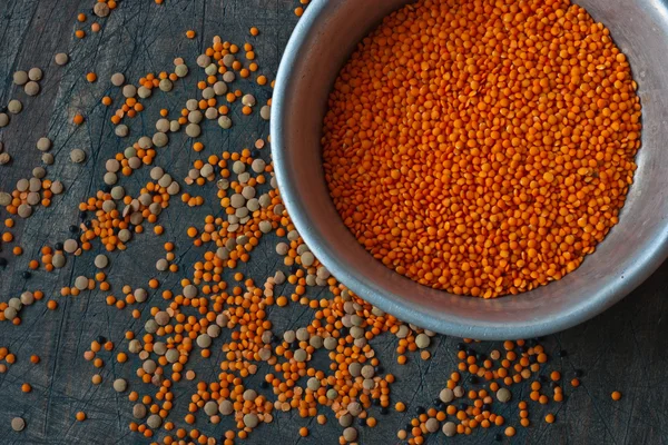 Aluminium dish with red lentil on a dark background with assorte — Stock Photo, Image