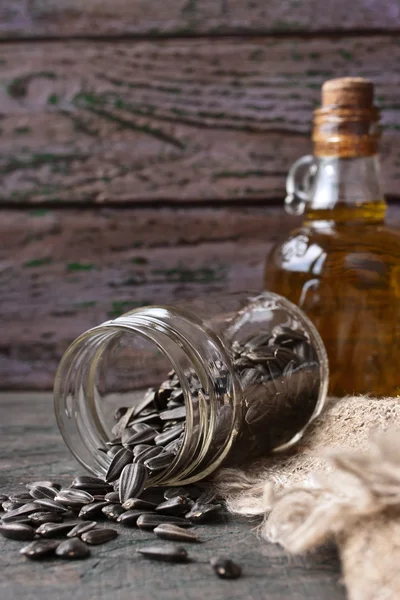 Sunflower seeds in a glass jar on the wooden table — Stock Photo, Image