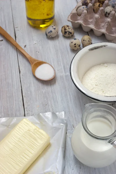 Ingredients for the pancakes on the white table around the parch — Stock Photo, Image