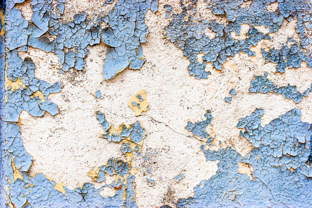 Old stone wall with cracked blue color paint background